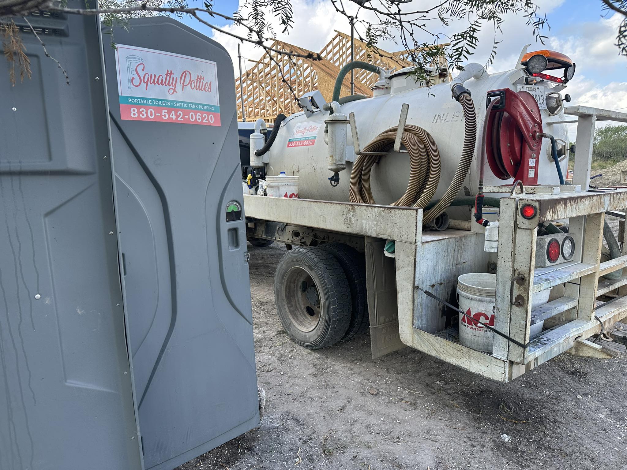 septic truck next to a port-a-potty